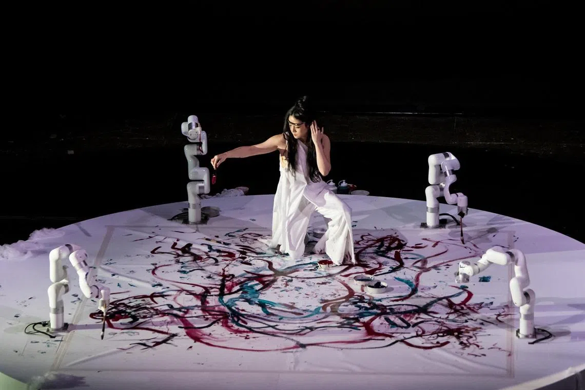 Canadian artist Sougwen Chen paints with four AI-driven robotic arms in Realm Of Silk as part of the Singapore International Festival of Arts (Sifa). 