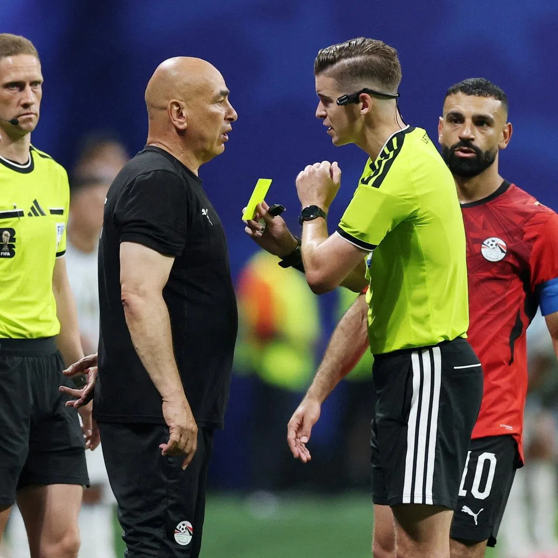 Egypt coach Hossam Hassan is shown a yellow card by referee Francois Letexier during his team’s round of 16 match against Argentina on July 7. Egypt went on to lose 3-2. Hassan said Egypt was “cheated”.