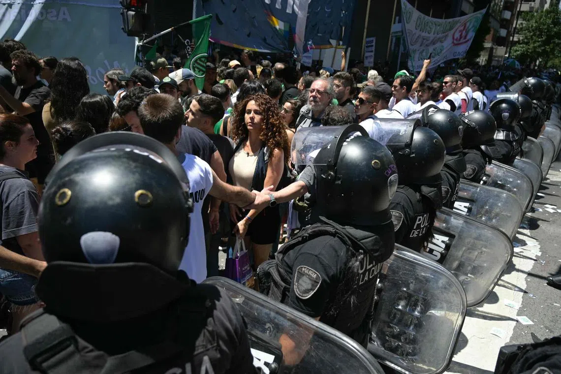 Riot police stand guard during a demonstration against Argentina's government of President Javier Milei.