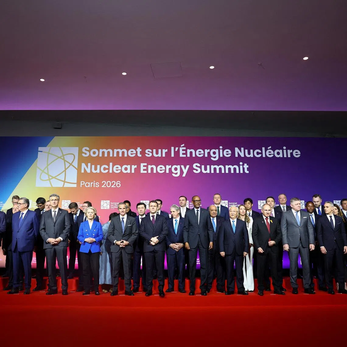French President Emmanuel Macron and Rafael Grossi, Director General of the International Atomic Energy Agency (IAEA), and European Commission President Ursula von der Leyen pose with heads of state and government for a family photo during the IAEA Nuclear Energy Summit in Paris, France, March 10, 2026.