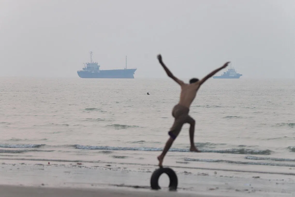 A person runs towards the sea while vessels are in the Strait of Hormuz near the beach of Bandar Abbas, Iran, June 30, 2026. Amirhosein Khorgooi/ISNA/via WANA (West Asia News Agency)via REUTERS ATTENTION EDITORS - THIS PICTURE WAS PROVIDED BY A THIRD PARTY.    ATTENTION EDITORS - THIS PICTURE WAS PROVIDED BY A THIRD PARTY. ISRAEL OUT. NO COMMERCIAL OR EDITORIAL SALES IN ISRAEL. NO ACCESS FOR ISRAELI MEDIA. NO USE BBC PERSIAN. NO USE VOA PERSIAN. NO USE MANOTO. NO USE IRAN INTERNATIONAL. NO USE RADIO FARDA. DIGITAL: NO USE BBC PERSIAN. NO USE VOA PERSIAN. NO USE MANOTO. NO USE IRAN INTERNATIONAL. NO USE RADIO FARDA.