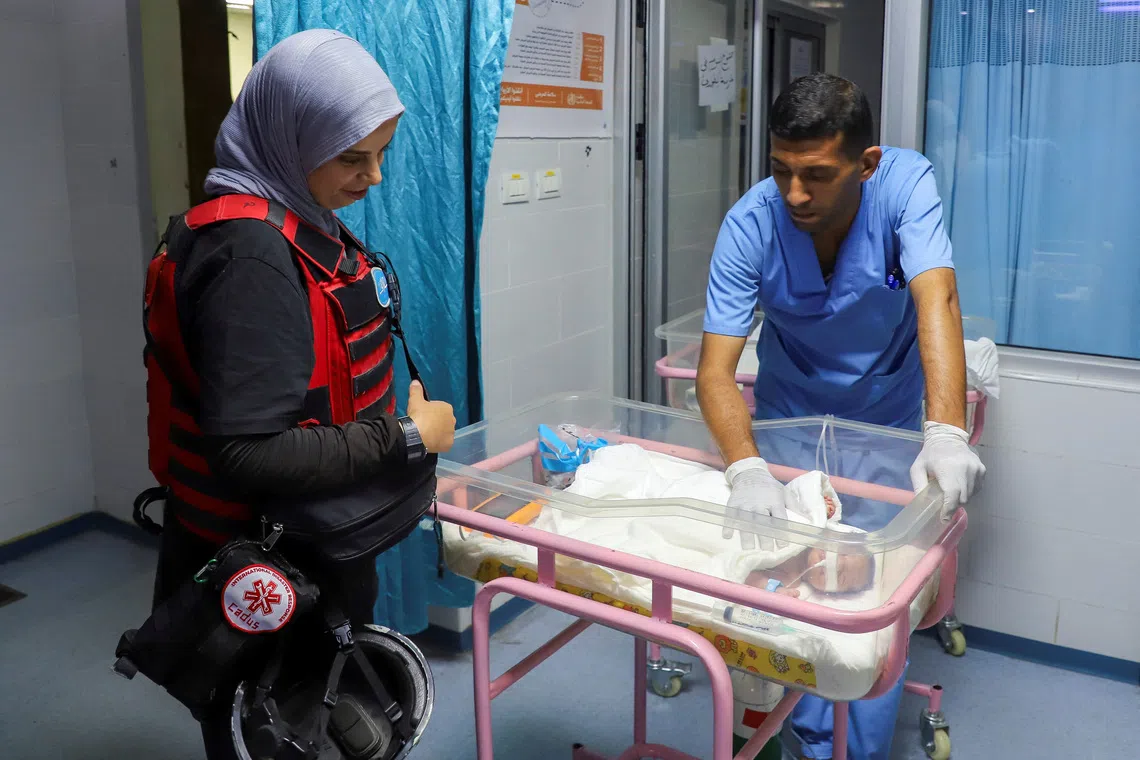 A medical worker prepares to evacuate a premature baby from Al Helo International Hospital to be transported to a hospital in southern Gaza for further medical care, amid an Israeli military operation, in Gaza City October 3, 2025. REUTERS/Ebrahim Hajjaj