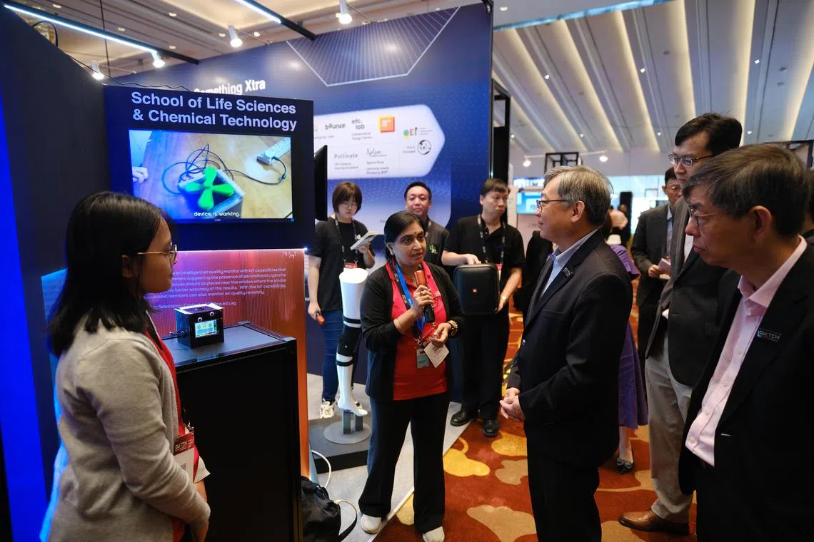 Minister for Trade and Industry Gan Kim Yong observing an air quality monitoring system developed by Ngee Ann Polytechnic during his visit to the SME Tech Day 2023 event held at Sands Expo and Convention Centre on Thursday.