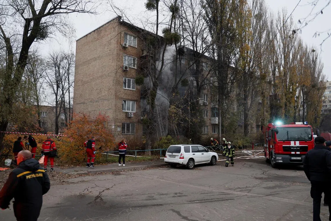 Firefighters putting out a blaze in a residential building that was hit by a Russian strike in Kyiv, Ukraine, on Nov 15, 2022.