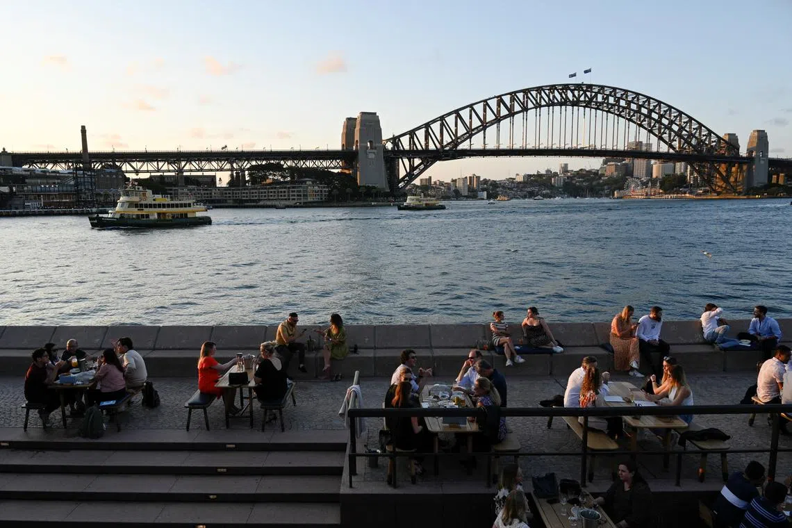 FILE PHOTO: Patrons dine-in at a bar by the harbour in the wake of coronavirus disease (COVID-19) regulations easing, following an extended lockdown to curb an outbreak, in Sydney, Australia, October 22, 2021. REUTERS/Jaimi Joy/File Photo