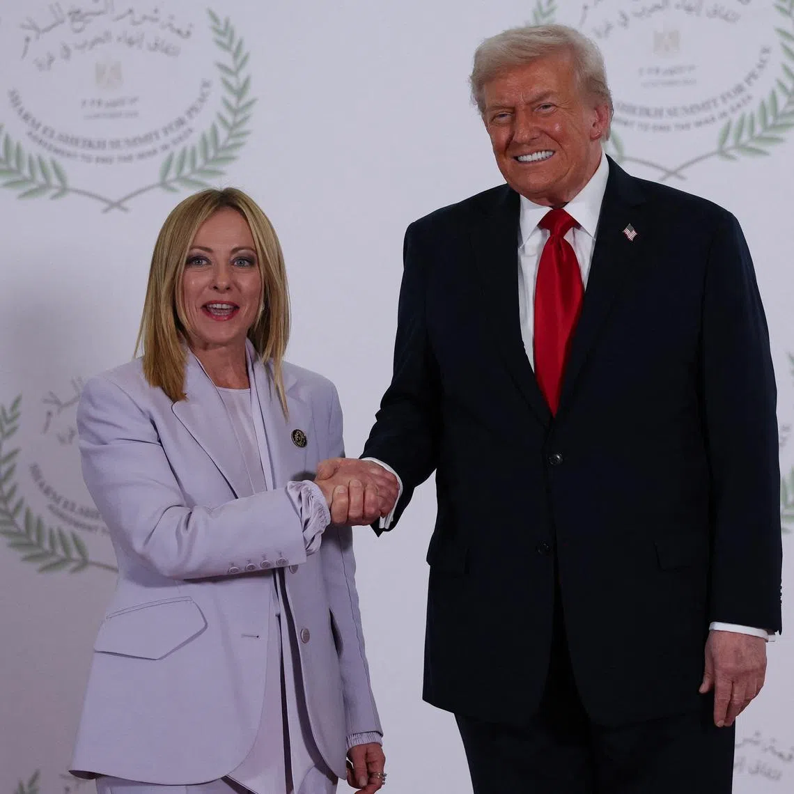 FILE PHOTO: U.S. President Donald Trump and Italian Prime Minister Giorgia Meloni shake hands as they pose for a photo, at a world leaders' summit on ending the Gaza war, amid a U.S.-brokered prisoner-hostage swap and ceasefire deal between Israel and Hamas, in Sharm el-Sheikh, Egypt, October 13, 2025. REUTERS/Suzanne Plunkett/Pool/ File Photo