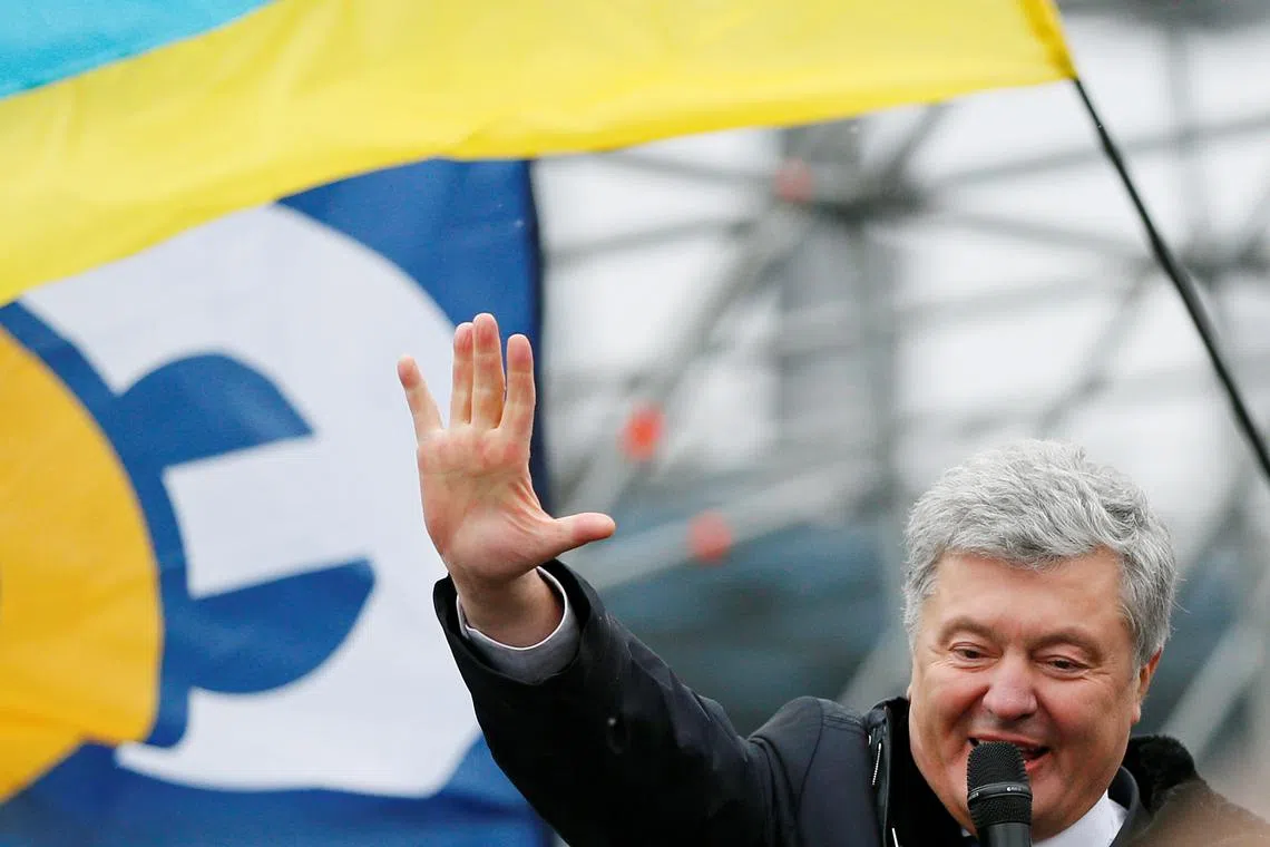 FILE PHOTO: Ukrainian former President Petro Poroshenko addresses his supporters upon arrival at Zhulyany airport in Kyiv, Ukraine January 17, 2022. REUTERS/Gleb Garanich/File Photo