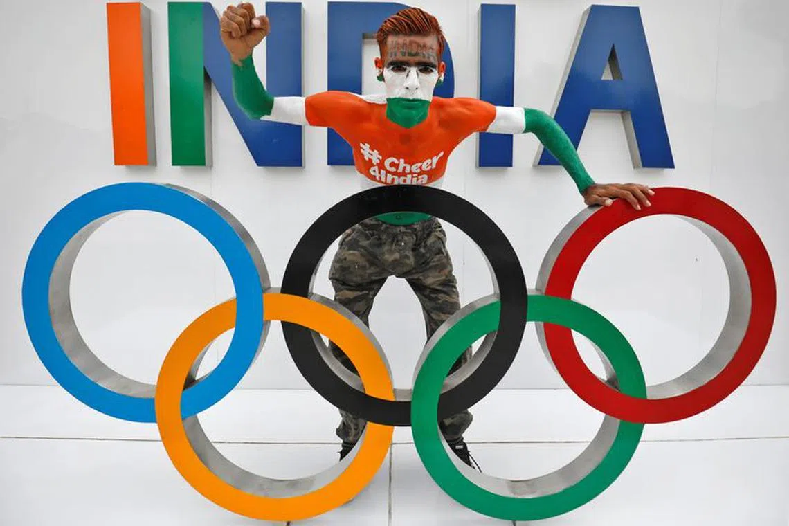 Arun Haryani, 38, a fan, poses with the Olympic rings as he cheers on India's team for the Tokyo 2020 Olympics, in Ahmedabad, India, July 22, 2021. REUTERS/Amit Dave/File Photo