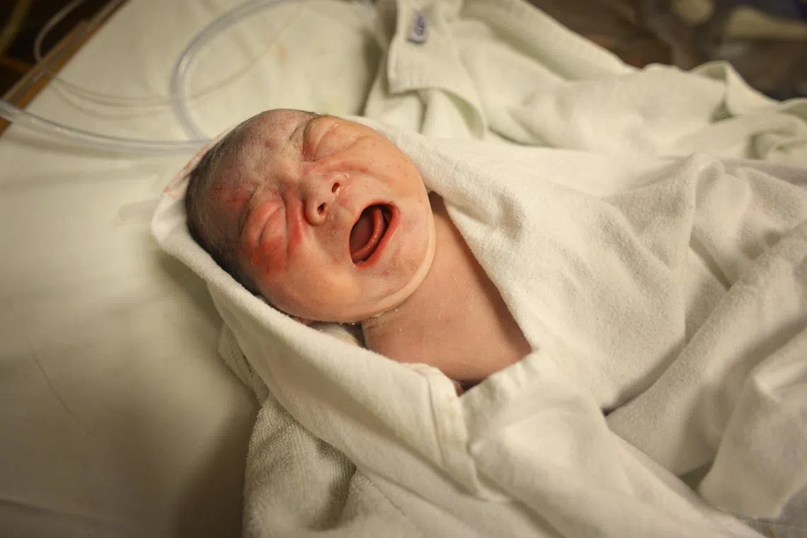 A newborn baby boy crying.