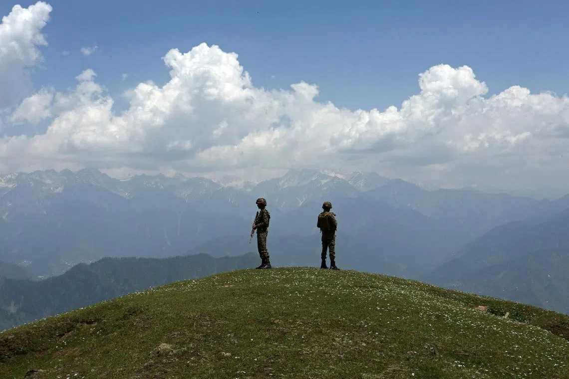 TOPSHOT - Indian army soldiers stand guard near the Line of Control (LoC) between Pakistan and India, in Poonch sector of India's Jammu region, on May 20, 2025. (Photo by Mukesh GUPTA / AFP)