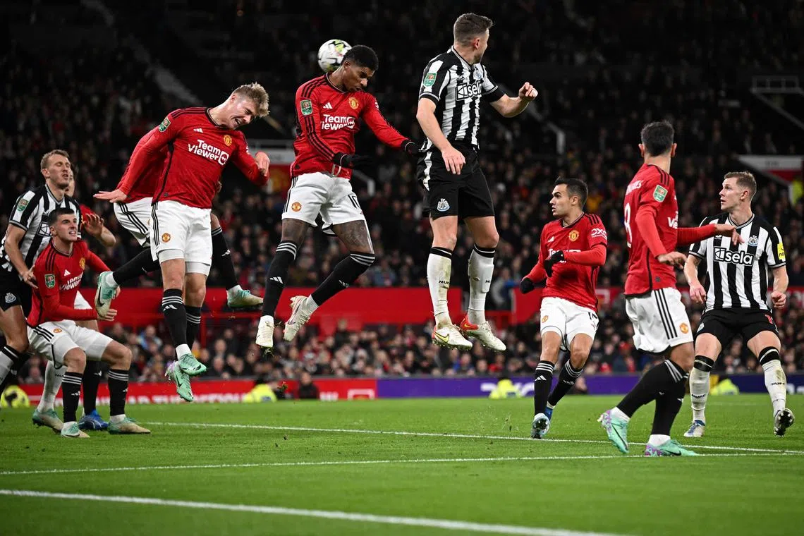 Manchester United's Marcus Rashford (centre) heading the ball as he defends the goal from a corner during the League Cup fourth round match between United and Newcastle at Old Trafford.