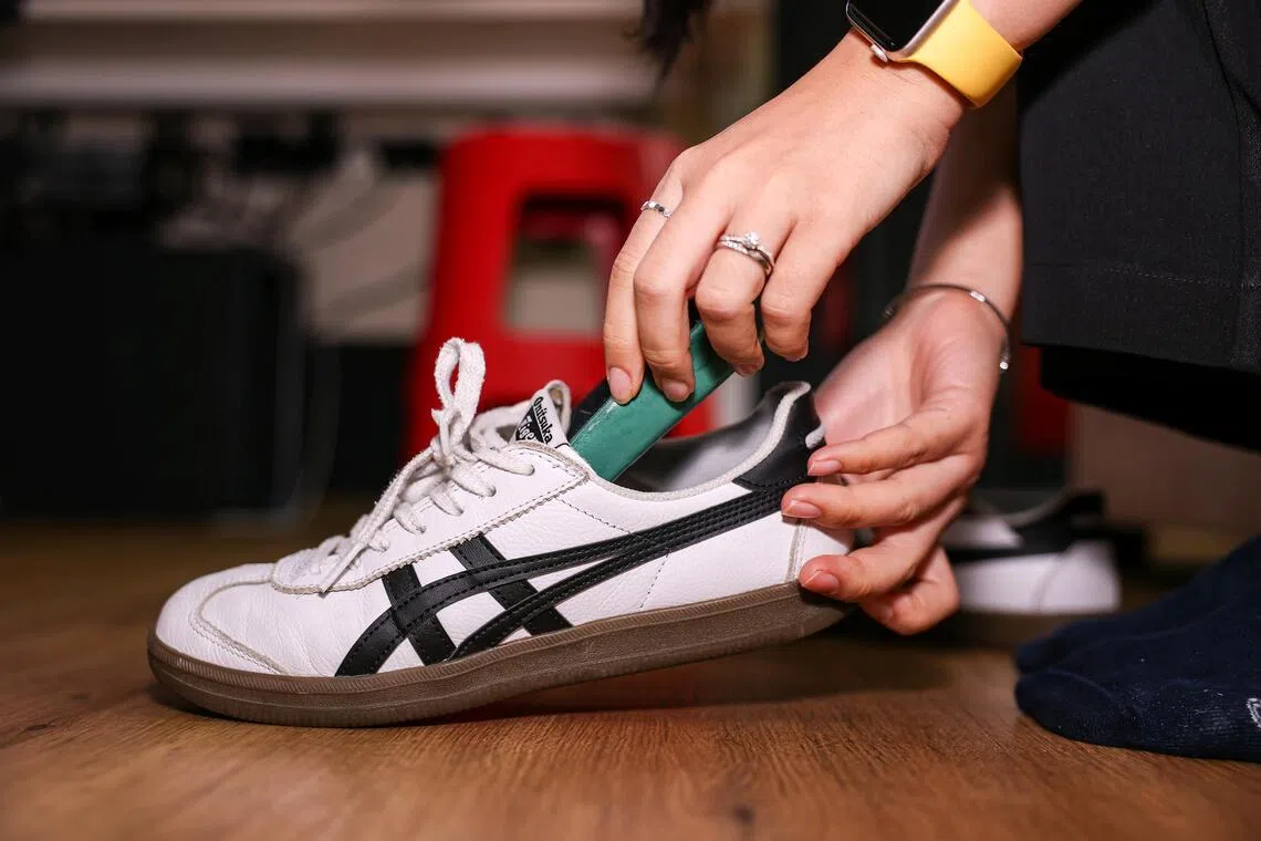 An insole being inserted into a shoe.