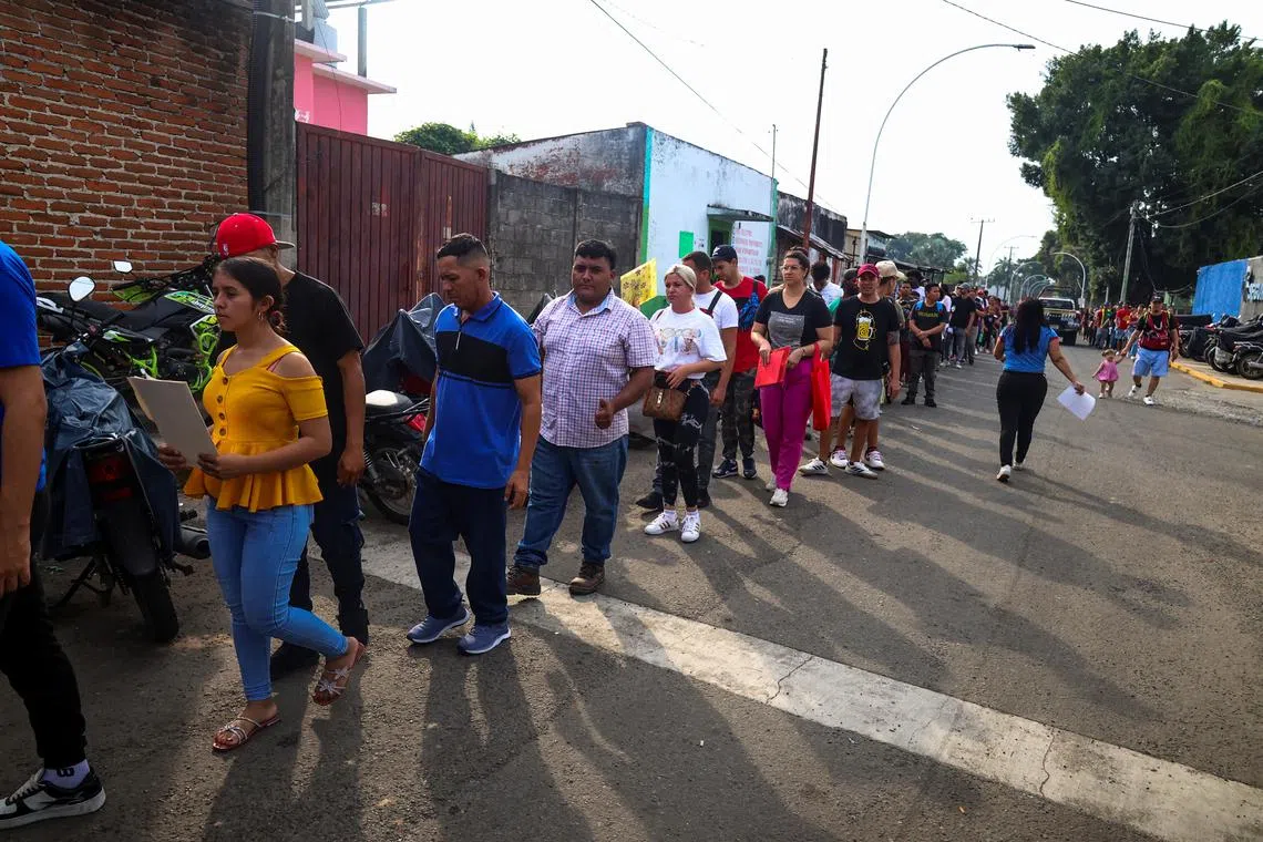 Migrants line up outside the office of the Mexico's National Migration Institute (INM) to process permits to travel through Mexico in an attempt to reach the U.S. border, in Tapachula, Mexico, December 30, 2024. REUTERS/Damian Sanchez