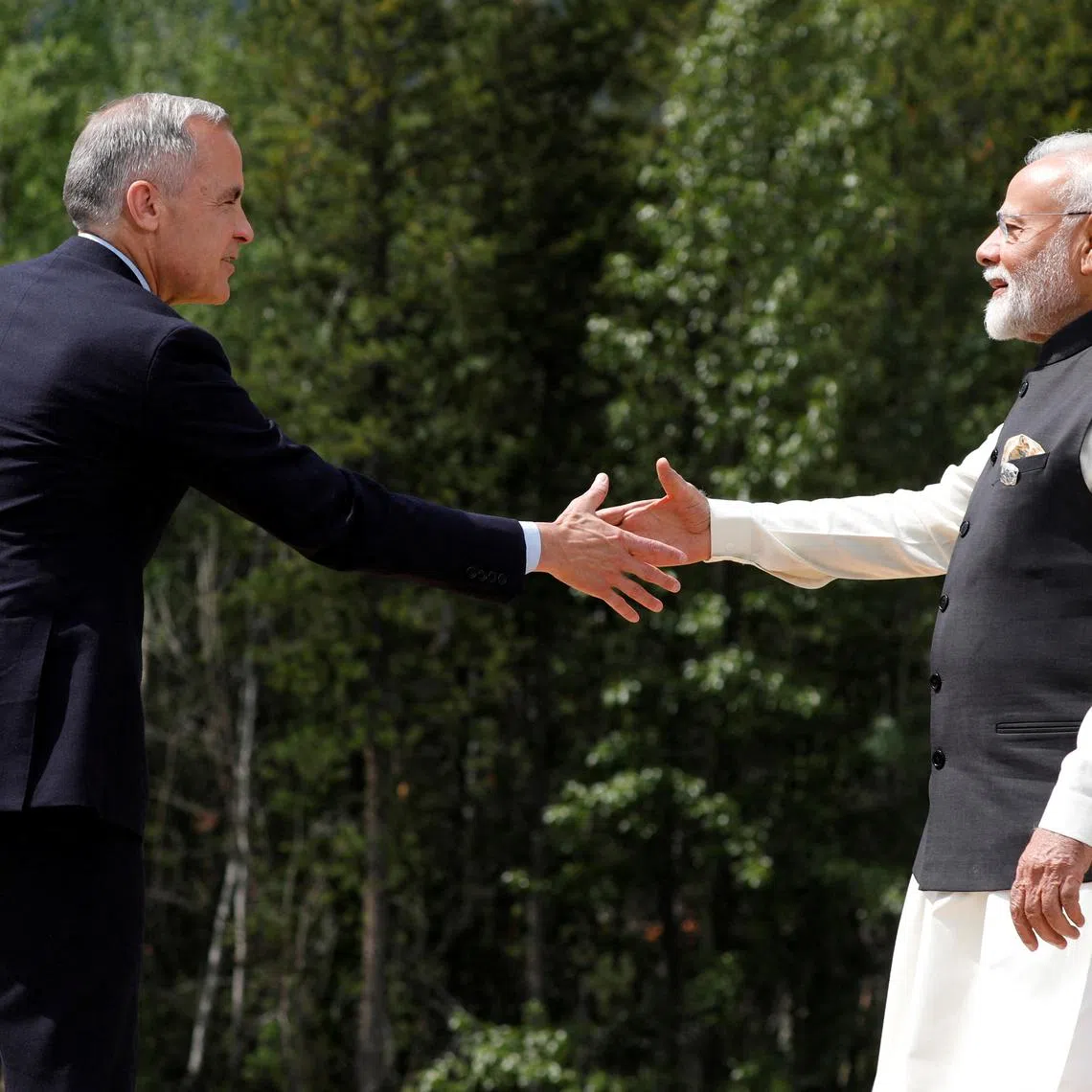 Canadian Prime Minister Mark Carney and India's Prime Minister Narendra Modi shake hands before posing for a photo during the G7 Leaders' Summit in Kananaskis, in Alberta, Canada, June 17, 2025. REUTERS/Amber Bracken