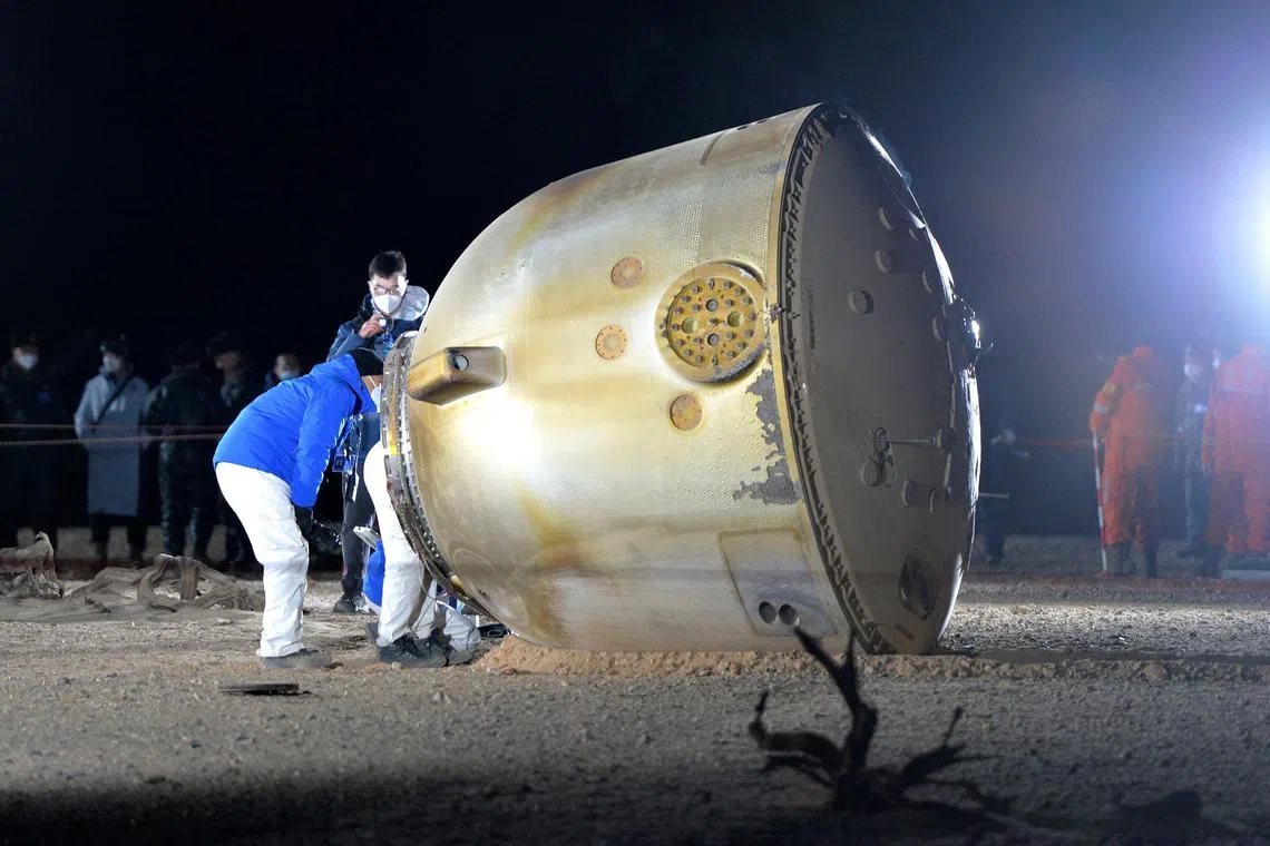 epa10347905 Staff works on the return capsule of the Shenzhou-14 manned spaceship after it touched down safely at the Dongfeng landing site, Inner Mongolia Autonomous Region, China, 04 December 2022. The three taikonauts of the Shenzhou-14 crew returned to Earth after completing a six-months mission aboard China's space station.  EPA-EFE/XINHUA / Li Gang CHINA OUT / MANDATORY CREDIT  EDITORIAL USE ONLY