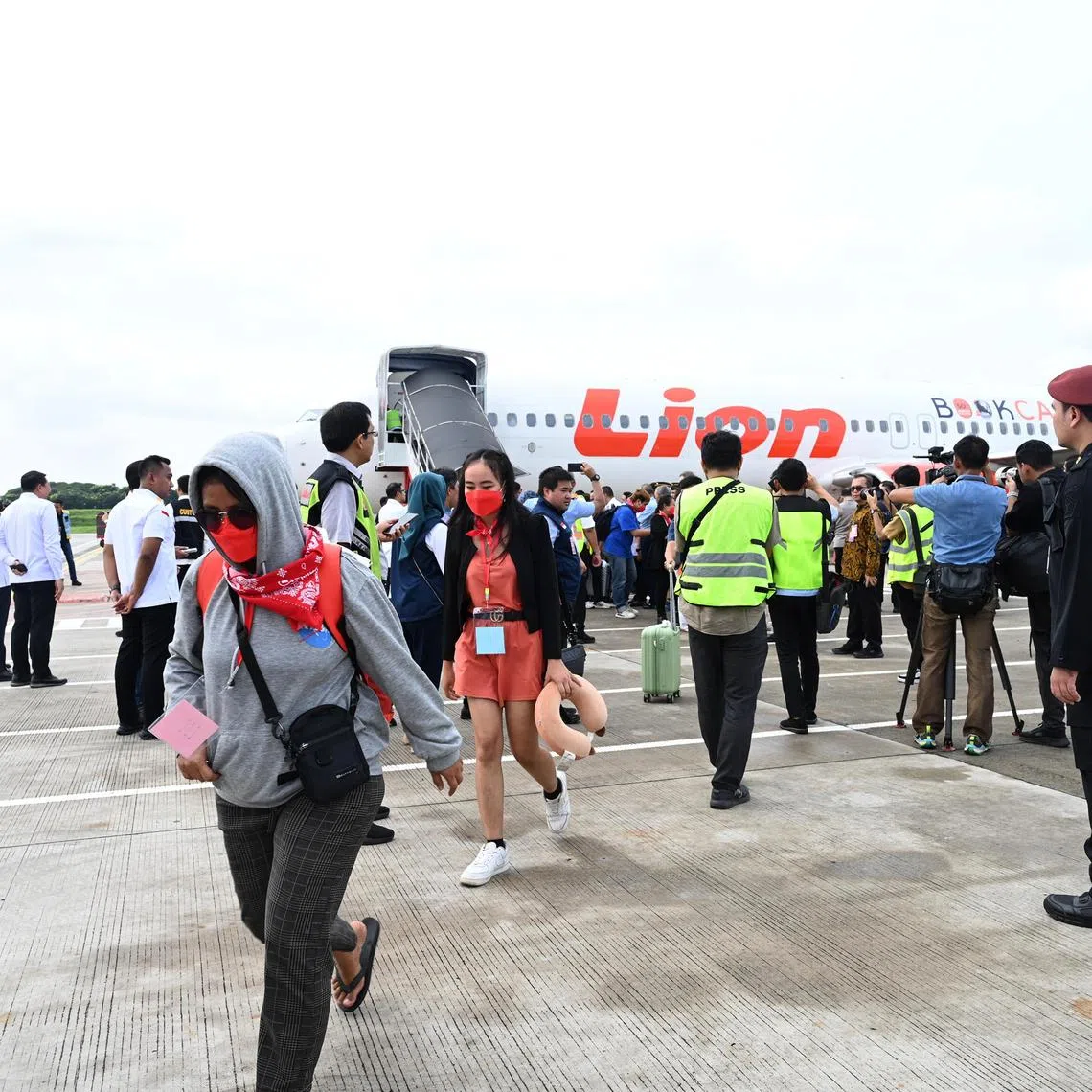 Indonesian workers arrive at Jakarta airport from Myanmar online scam compounds on March 18. The police said many scammers have moved to South-east Asia after a Chinese crackdown on networks.