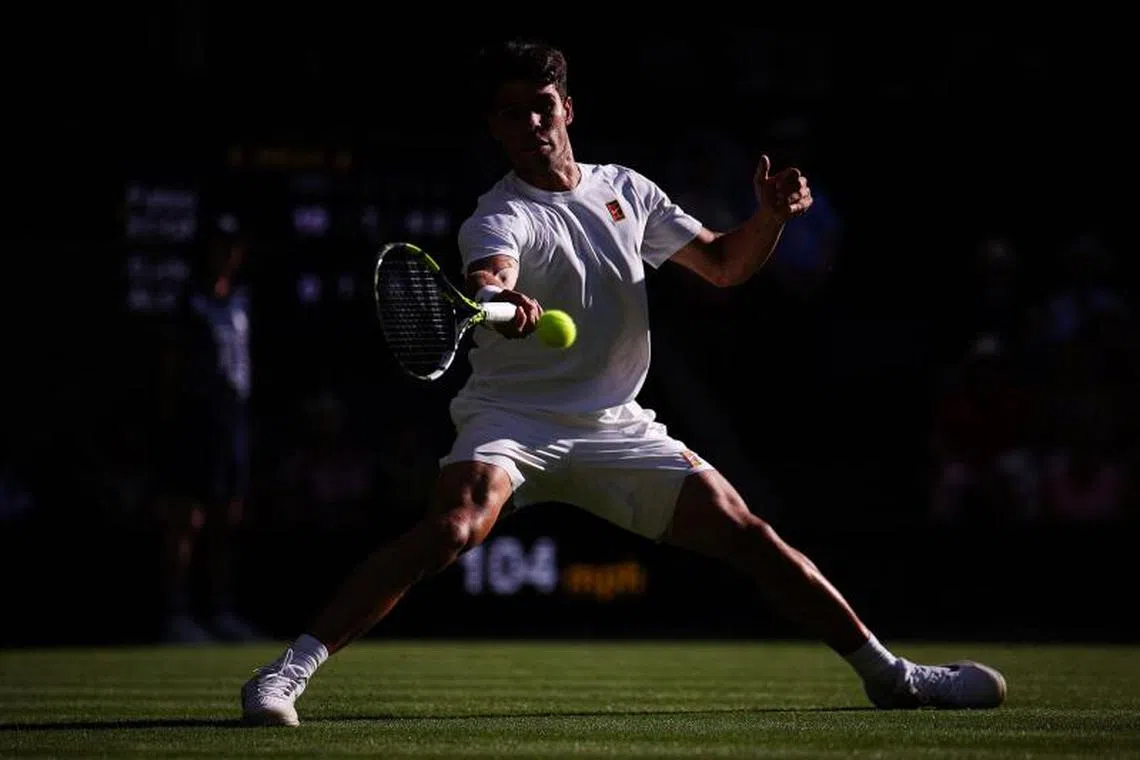 Spain's Carlos Alcaraz plays a forehand return to Italy's Fabio Fognini during their men's singles first round tennis match.