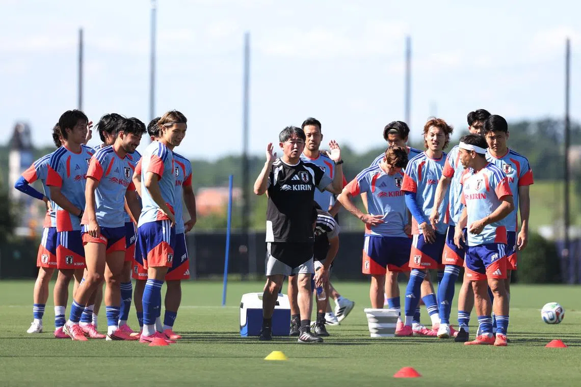Japan fitness coach Ryoichi Matsumoto giving instructions to Japan players during training in Nashville, Tennessee, on June 15.