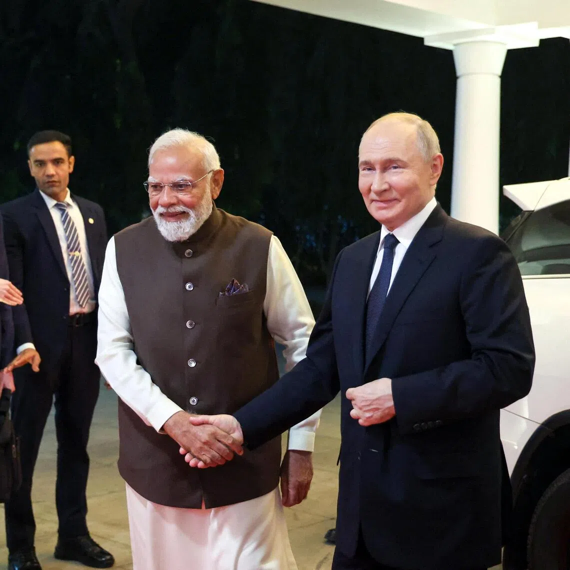 Indian Prime Minister Narendra Modi (left) and Russian President Vladimir Putin arriving for an informal dinner at the Prime Minister's Residence in New Delhi, on Dec 4.