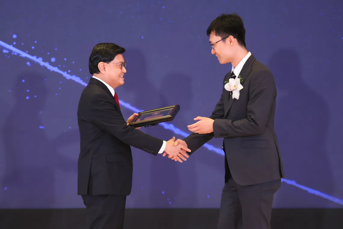 National Research Foundation Chairman Heng Swee Keat (left) presents the Young Scientist Award to Dr Liu Boxiang.