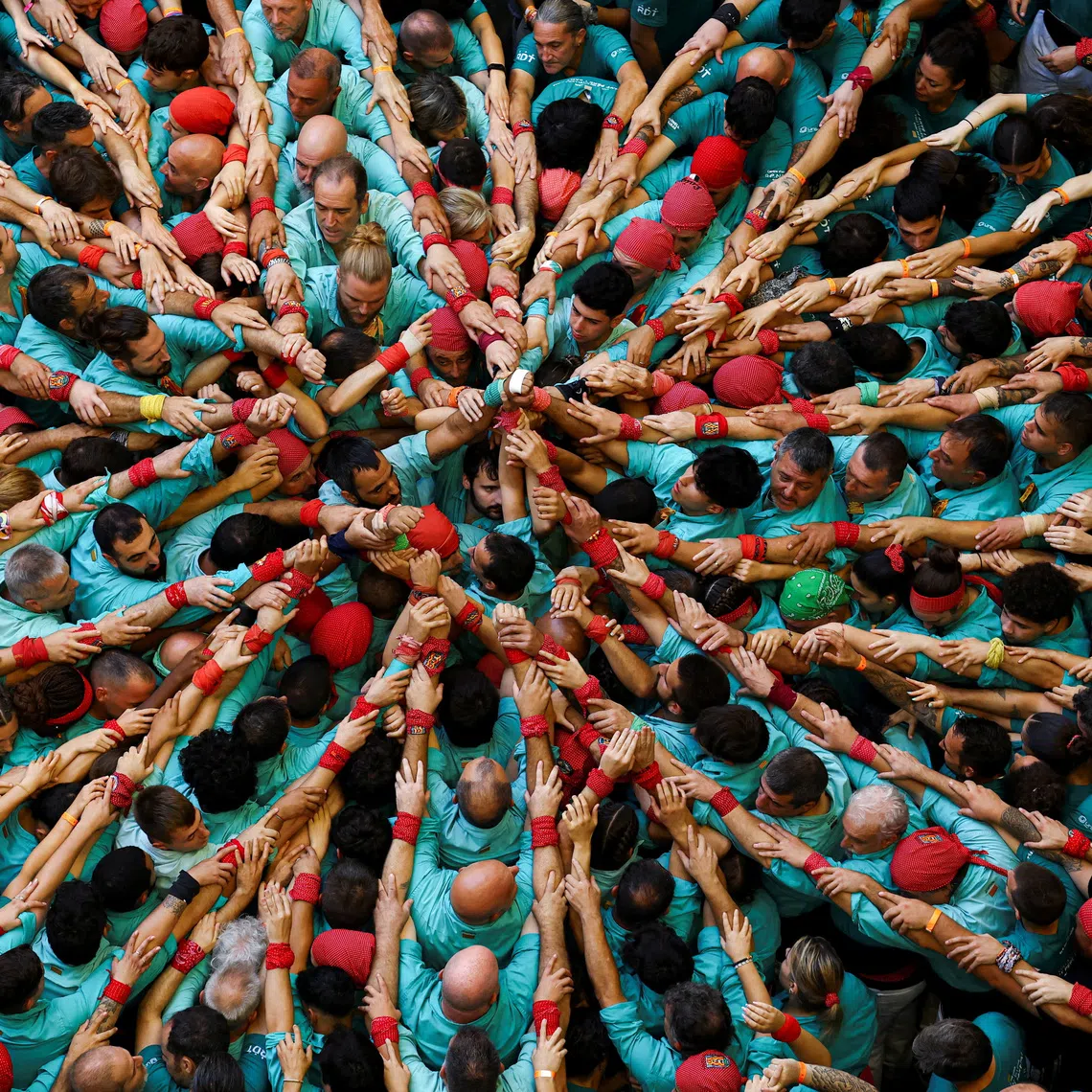 Members of "Colla Castellera de Sant Pere i Sant Pau" start to form a human tower called a "castell" in Catalan, during a biannual competition in Tarragona, Spain, October 4, 2026. REUTERS/Albert Gea TPX IMAGES OF THE DAY