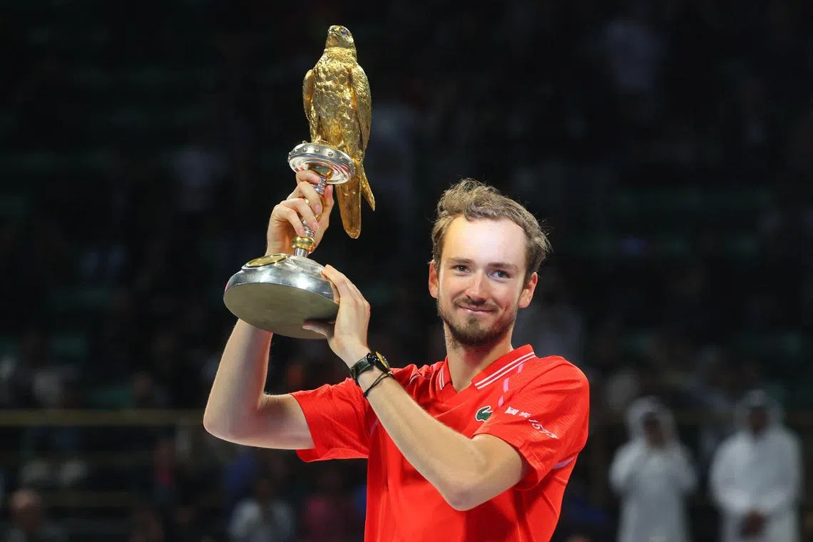 Russia's Daniil Medvedev celebrates with his trophy after defeating Britain's Andy Murray in the Qatar Open.