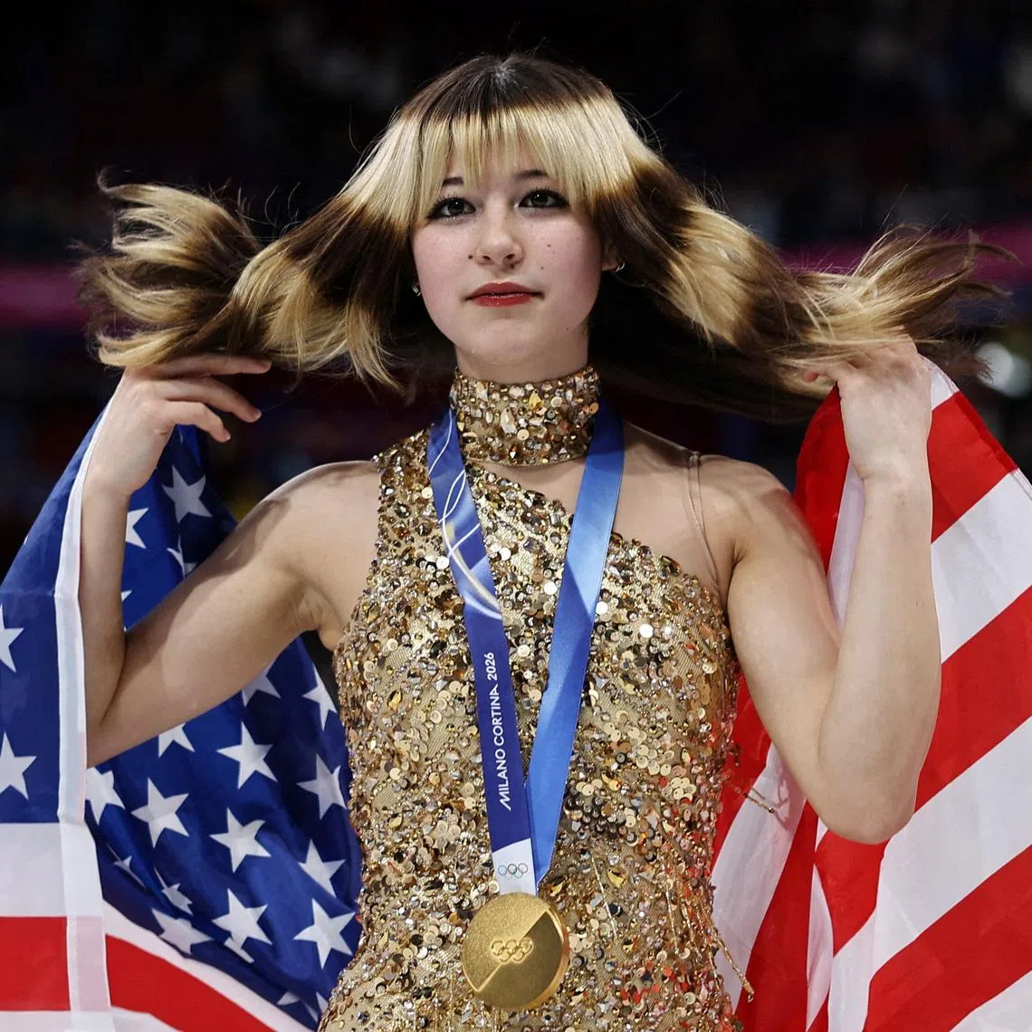 Milano Cortina 2026 Olympics - Figure Skating - Women Single Skating - Victory Ceremony - Milano Ice Skating Arena, Milan, Italy - February 19, 2026. Gold medallist Alysa Liu of United States celebrates with her national flag after winning the Women Single Skating REUTERS/Amanda Perobelli     TPX IMAGES OF THE DAY