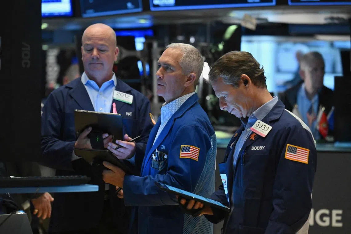 Traders work on the floor of the New York Stock Exchange, in New York City.