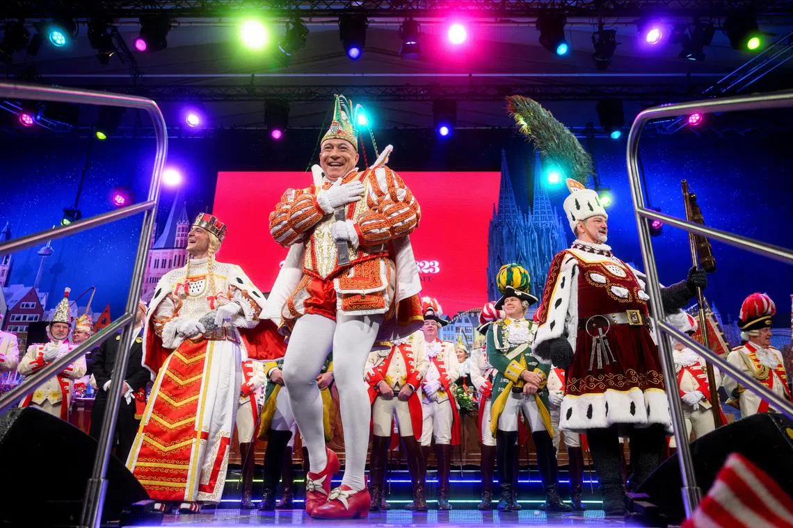 FILE PHOTO: Members of the Cologne Dreigestirn Hendrik Ermen as Maiden (Jungfrau),  Rene Kloever as Prince, and Michael Samm as Peasant (Bauer) perform at a Carnival session, in Cologne, Germany February 13, 2025. REUTERS/Jana Rodenbusch/File Photo
