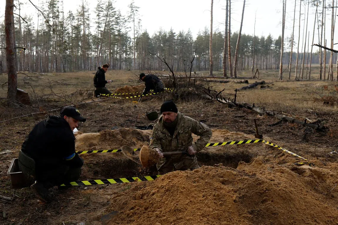 A team from the humanitarian mission "Black Tulip" exhuming the bodies of fallen Ukrainian soldiers in Yampil, Ukraine, on Jan 2, 2023. 