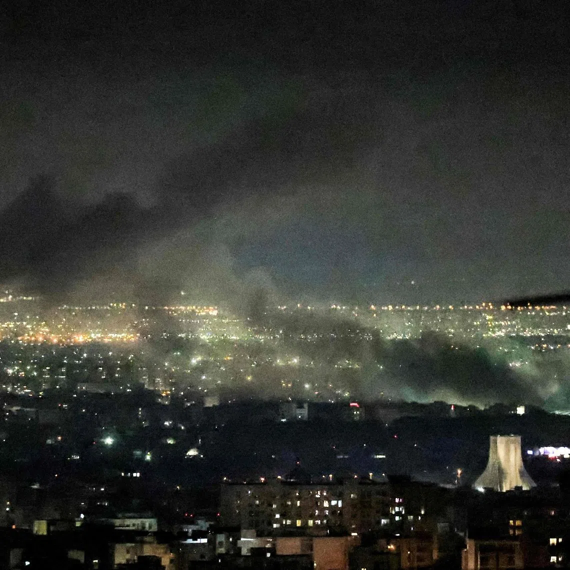 Smoke rising from the site of air strikes in western Tehran on March 10.