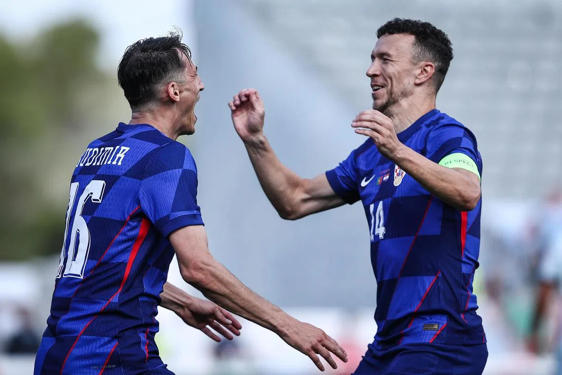Croatia's Ante Budimir (left) celebrates scoring the winning goal with teammate Ivan Perisic.