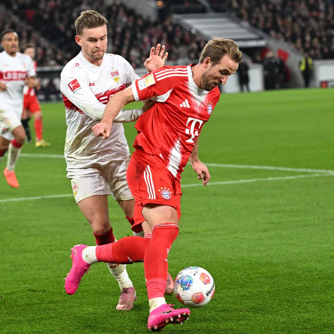 Soccer Football - Bundesliga - VfB Stuttgart v Bayern Munich - MHPArena, Stuttgart, Germany - December 6, 2025 Bayern Munich's Harry Kane in action with VfB Stuttgart's Maximilian Mittelstadt REUTERS/Angelika Warmuth