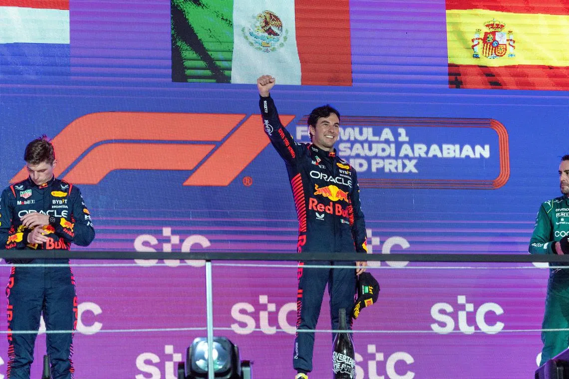 Winner Sergio Perez (centre) of Red Bull, second-placed Max Verstappen of Red Bull and third-placed Fernando Alonso of Aston Martin during the podium ceremony for the Saudi Arabian Grand Prix.