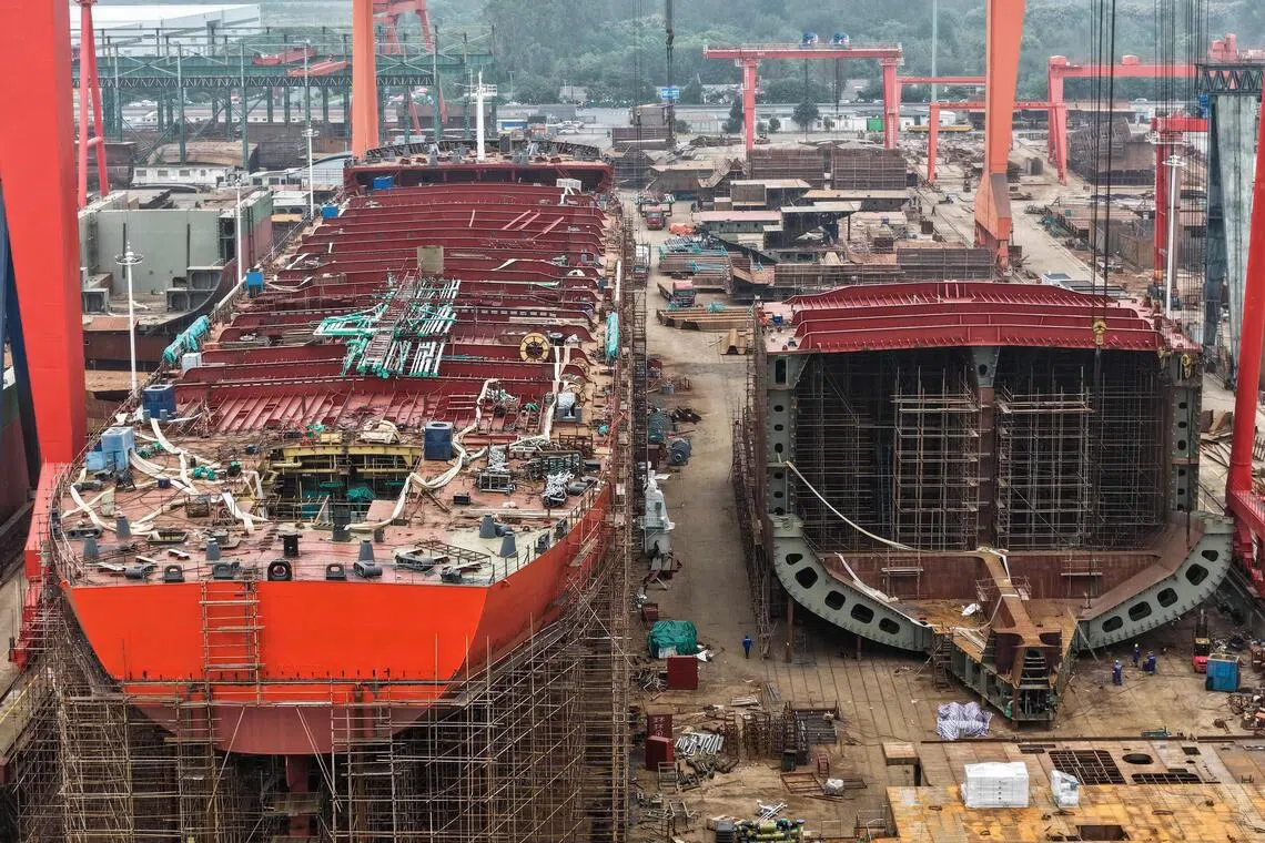 This aerial view shows ships under construction at a shipbuilding facility along the Yangtze River in Yangzhou, east China's Jiangsu province, on October 14, 2025. (Photo by -STR / AFP) / China OUT