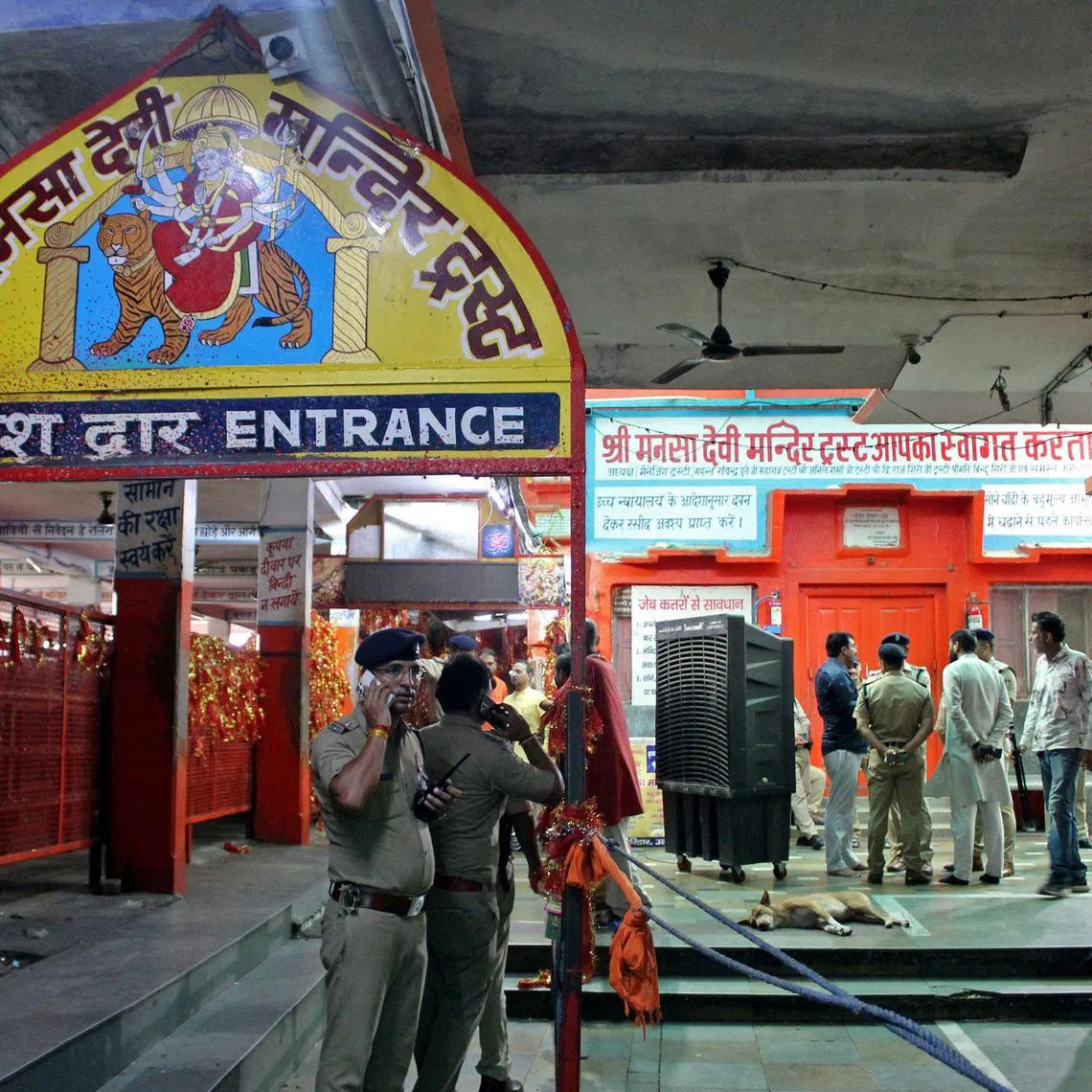 Police officials stand guard near the site of a stampede at the Mansa Devi temple in Haridwar, on July 27, 2025. At least six people were crushed to death at a popular Hindu temple in northern India's Uttarakhand state on July 27, officials said, after a massive crowd surge. (Photo by AFP)