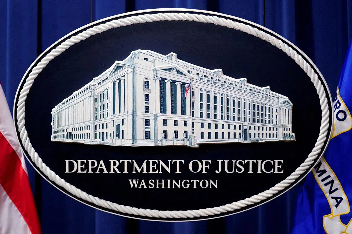 FILE PHOTO: A U.S. Justice Department logo or seal showing Justice Department headquarters, known as \"Main Justice,\" is seen behind the podium in the Department's headquarters briefing room, January 24, 2023.  REUTERS/Kevin Lamarque/File Photo