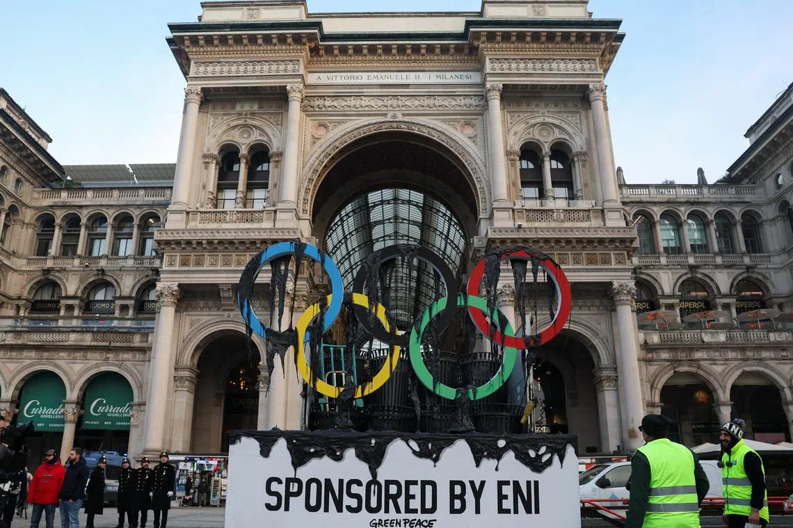 Civic workers remove a symbolic installation by environmental activists from Greenpeace, on the day they stage a protest near the Duomo di Milano, as the Olympic torch arrives in Milan, Italy, February 5, 2026. REUTERS/Claudia Greco