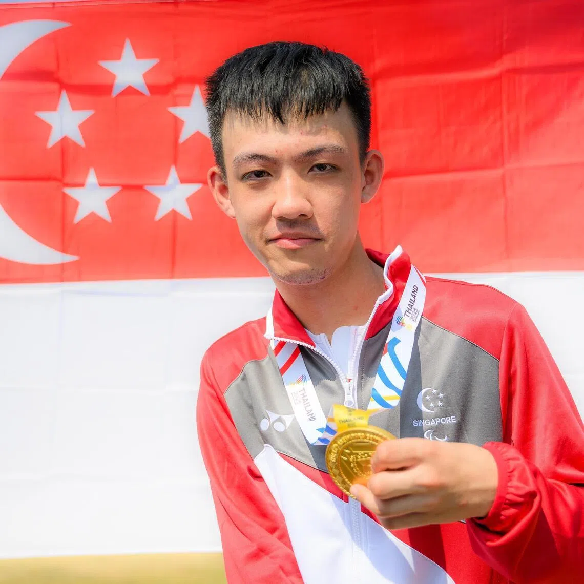 Singapore’s Sebastian Tan posing with his medal after winning gold at the Asean Para Games in the mixed individual time trial T1 - T2 event.