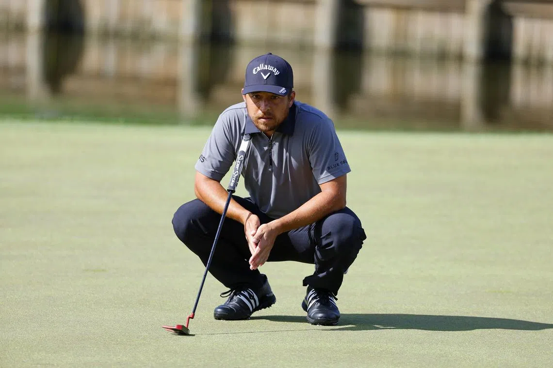 FILE PHOTO: Mar 14, 2025; Ponte Vedra Beach, Florida, USA; Xander Schauffele eyes his putt on the eighteenth green during the second round of The Players Championship golf tournament at TPC Sawgrass. Mandatory Credit: Jeff Swinger-Imagn Images/File Photo
