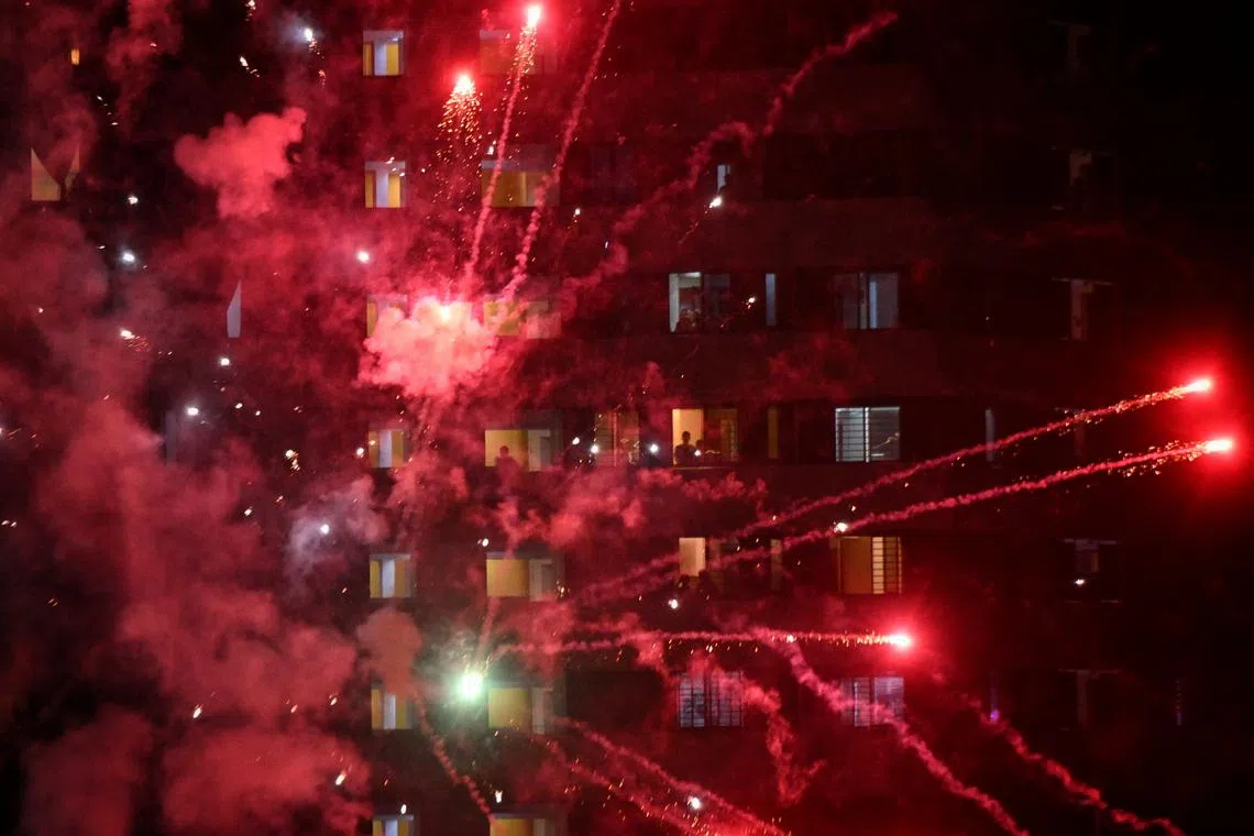People from the neighbouring flats enjoying the fireworks display during the One Punggol New Year Eve celebrations.