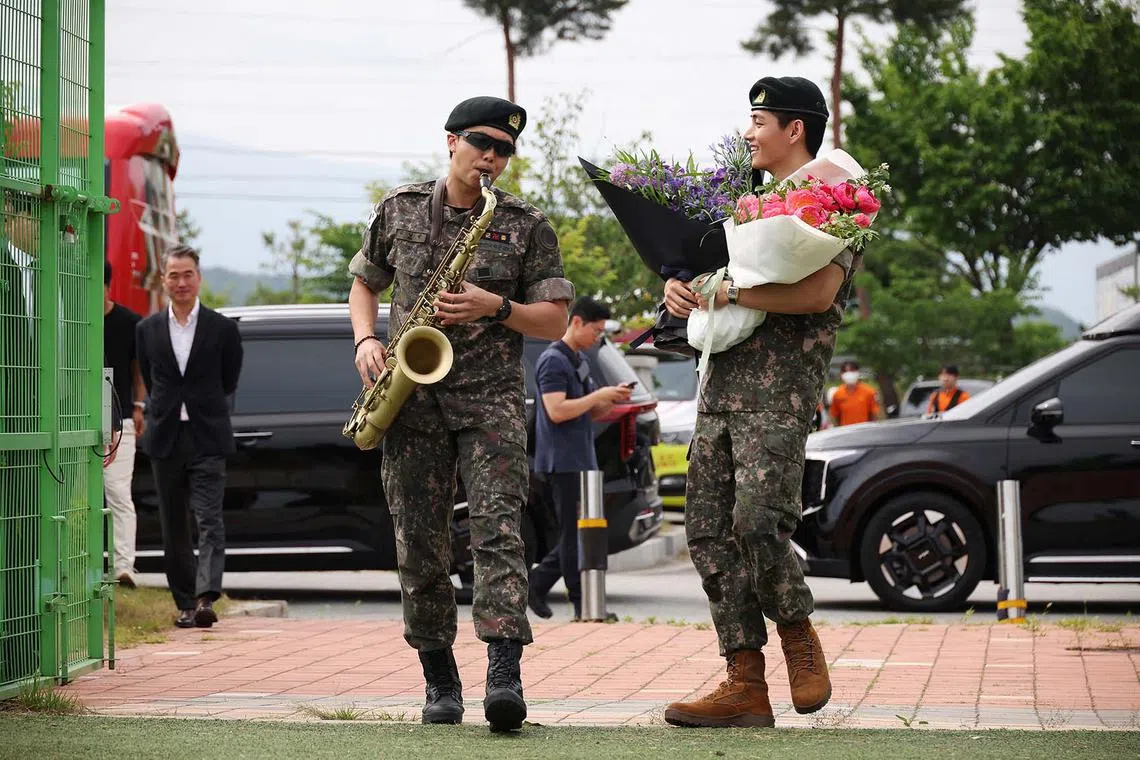 BTS members RM (left) and V, arriving for an event after being discharged from South Korea’s mandatory military service, in Chuncheon, South Korea, June 10, 2025. 