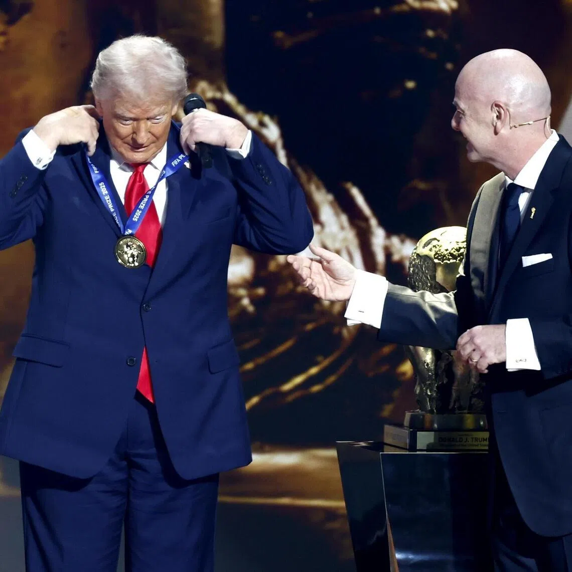US President Donald Trump receiving the FIFA Peace Prize from FIFA president Gianni Infantino during the World Cup 2026 draw at the Kennedy Center in Washington DC on Dec 5.