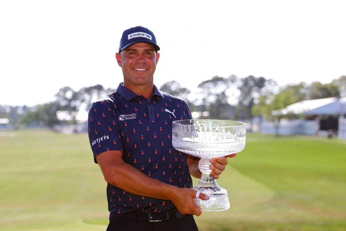 Gary Woodland of the United States poses with the trophy on the 18th green after winning the Texas Children's Houston Open.