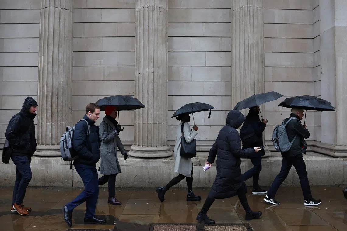 FILE PHOTO: Commuters walk during the morning rush hour near the Bank of England in the City of London financial district in London, Britain, February 8, 2024. REUTERS/Toby Melville/ File photo