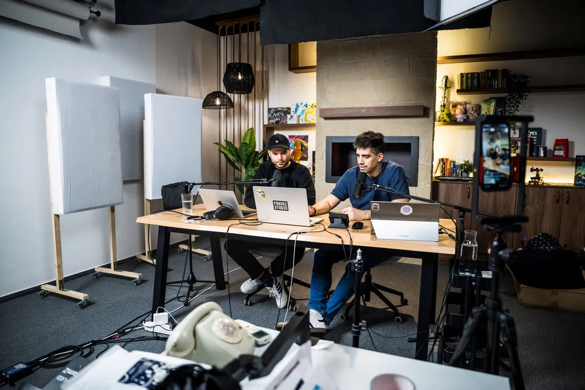 Adam Nagy and his co-host, Barnabas Bucsek, talk during their usual morning live broadcast of Jolvanezigy (\"It’s okay this way\") in Budapest, Hungary, November 7, 2025. REUTERS/Marton Monus