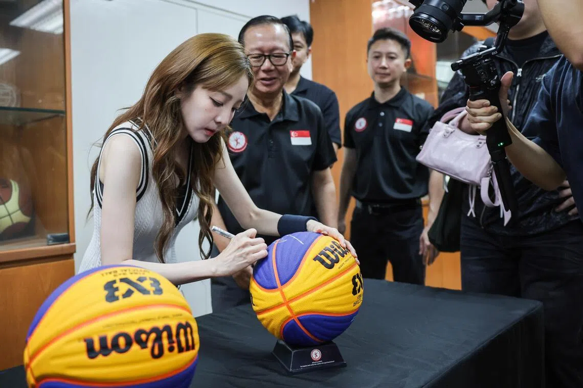 South Korean singer Sandara Park, signing her autograph on commemorative basketballs during her visit at the Basketball Association of Singapore, on July 17, 2026.