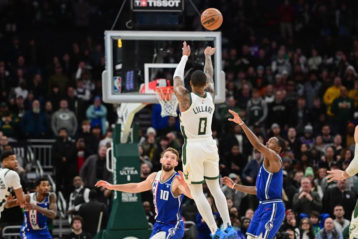 Milwaukee Bucks guard Damian Lillard scoring the game-winning three-point basket at the end of overtime against the Sacramento Kings at Fiserv Forum on Jan 14. The Bucks won 143-142.