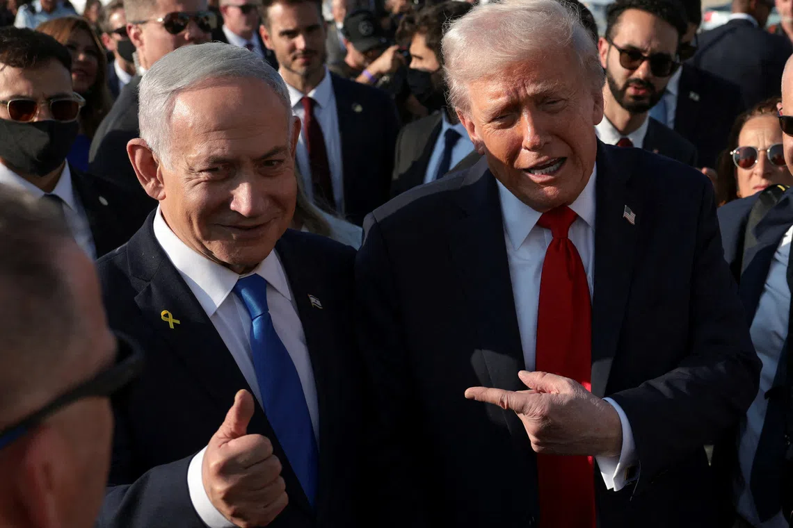 FILE PHOTO: U.S. President Donald Trump  gestures next to Israeli Prime Minister Benjamin Netanyahu at Ben Gurion International Airport in Lod, Israel, October 13, 2025. REUTERS/Evelyn Hockstein/File Photo