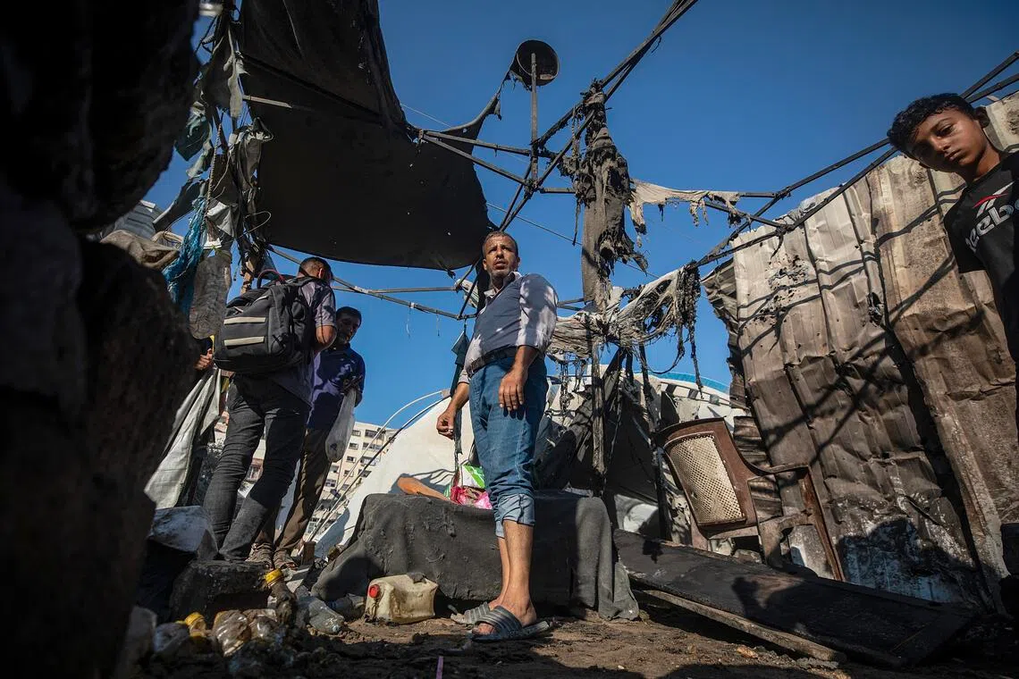 Palestinians inspecting the damage following an Israeli airstrike in Gaza City on Aug 27.